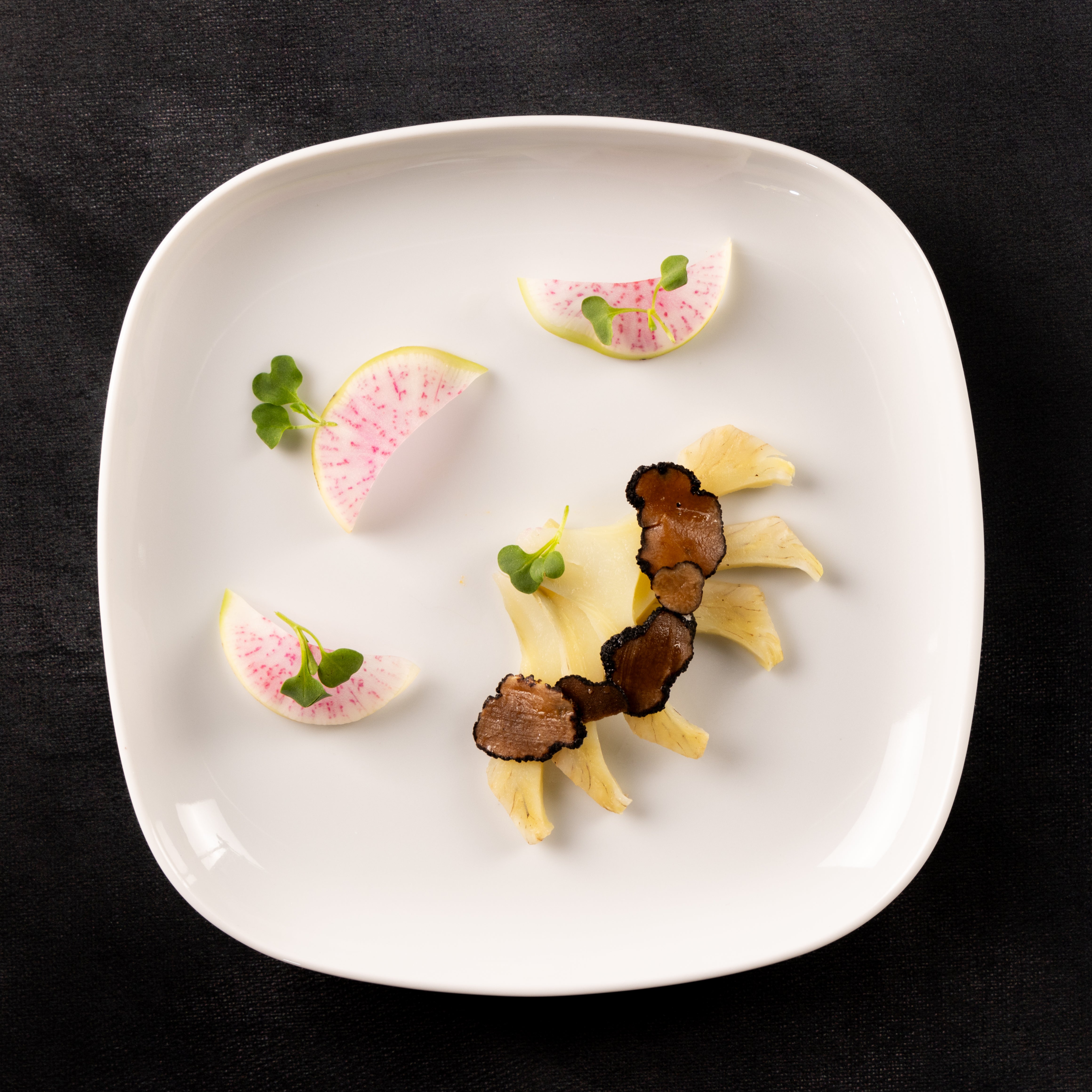 a plate of food on a black surface