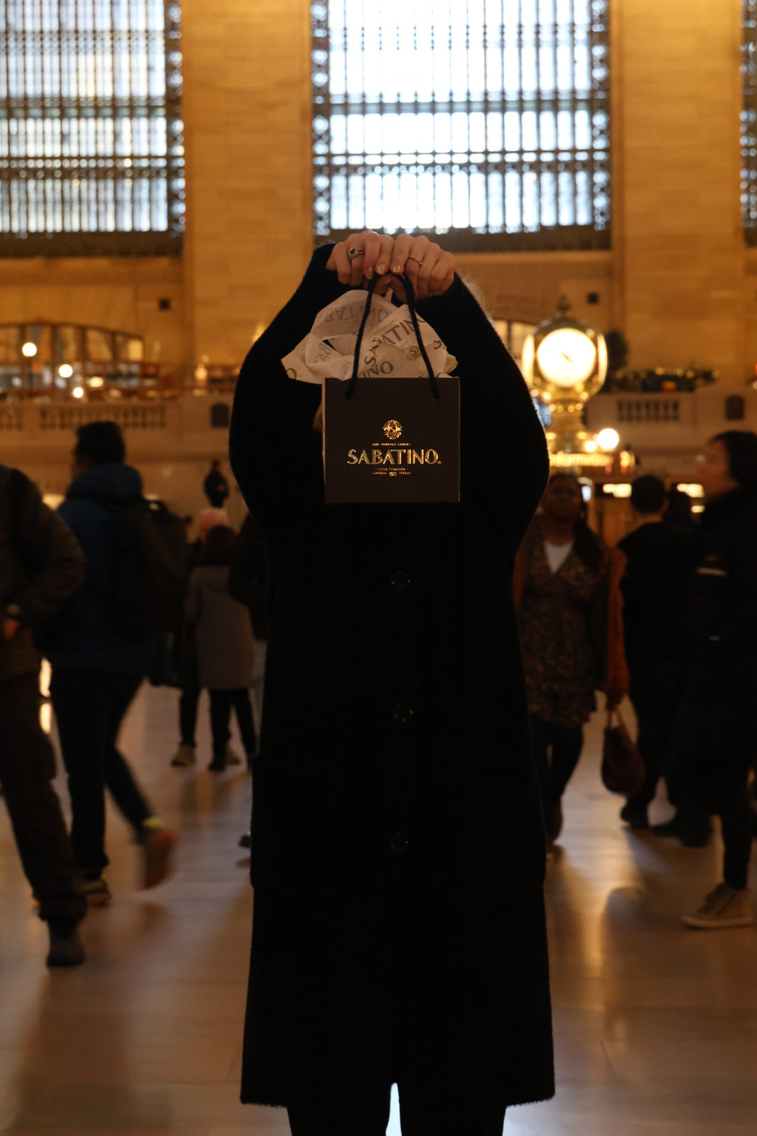 a person holding a bag in front of their face