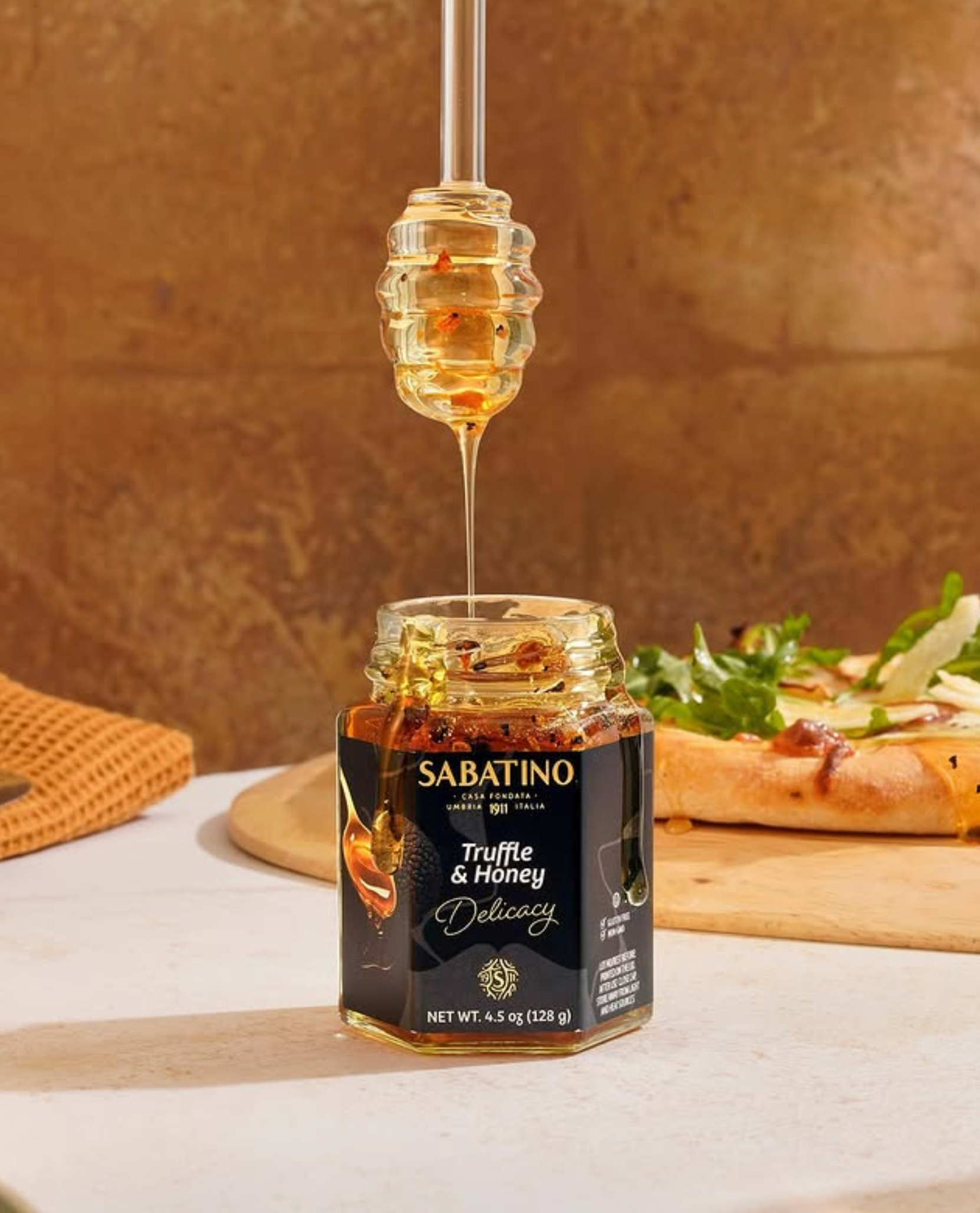 a jar of honey being poured into a jar