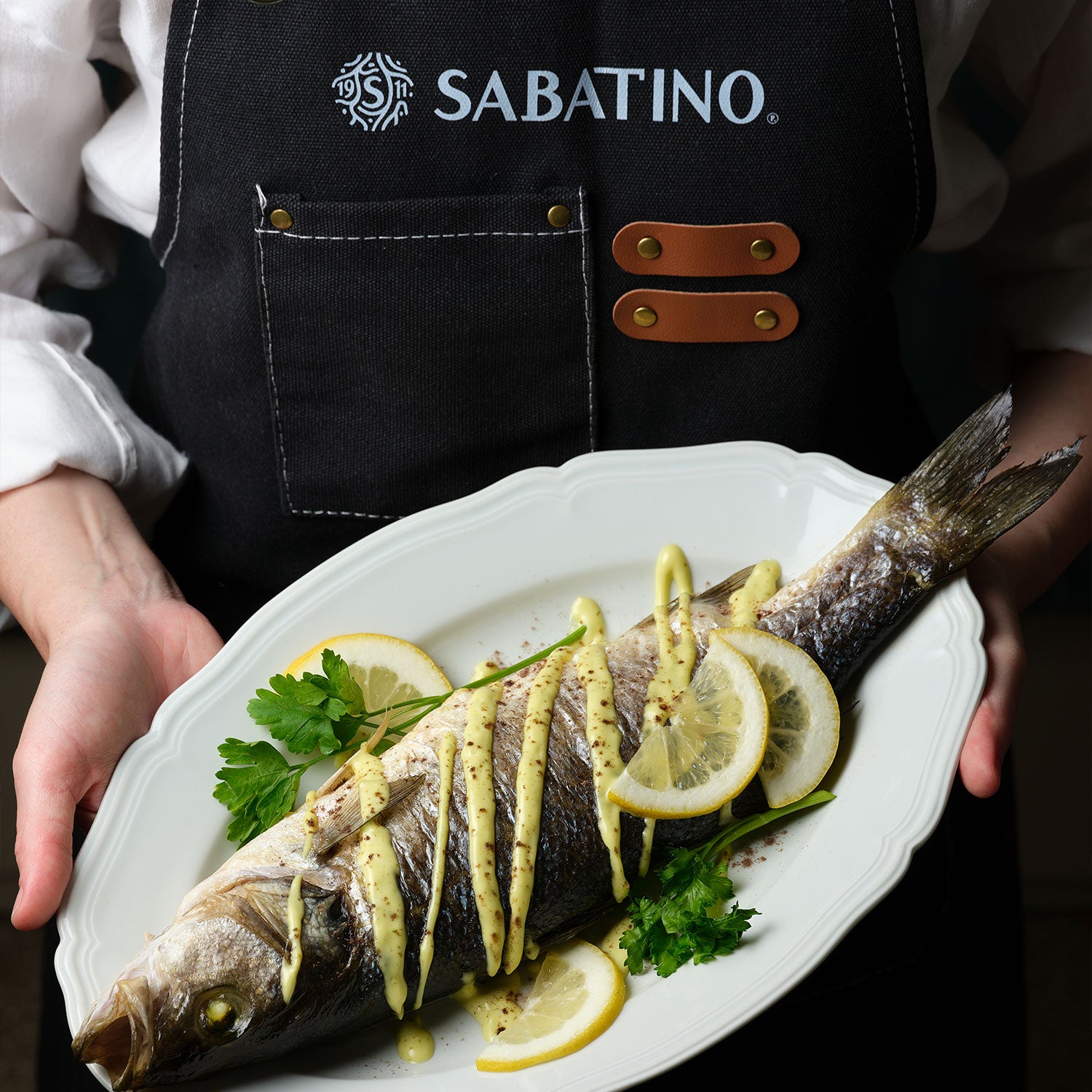 a person holding a plate of fish