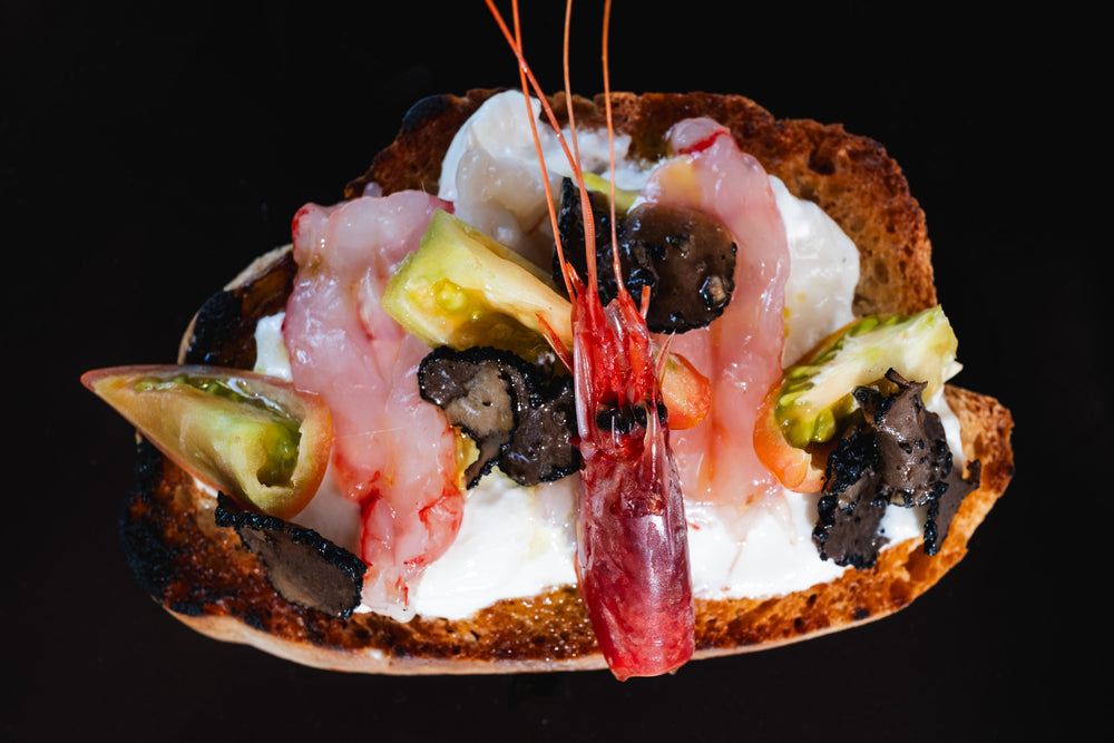 Bruschetta with Buffalo Stracciatella, Raw Shrimp, Tomatoes, and Black Truffle Carpaccio