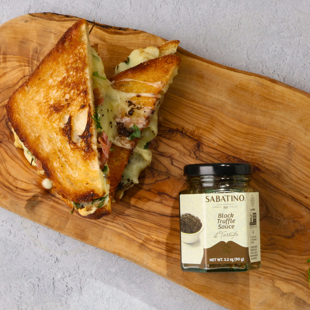 a grilled cheese sandwich and a jar of sauce