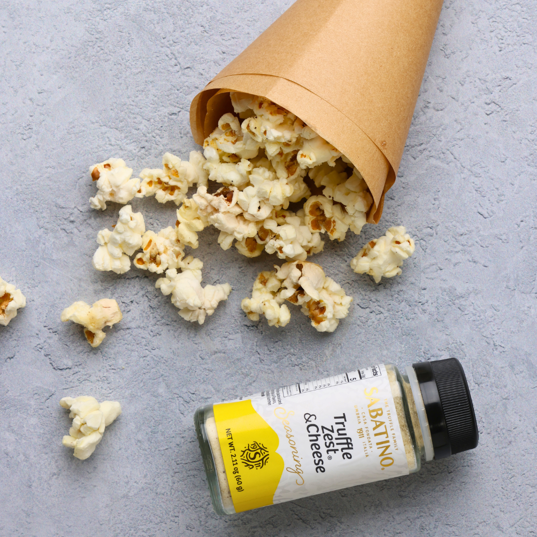 a paper bag with popcorn spilling out of it