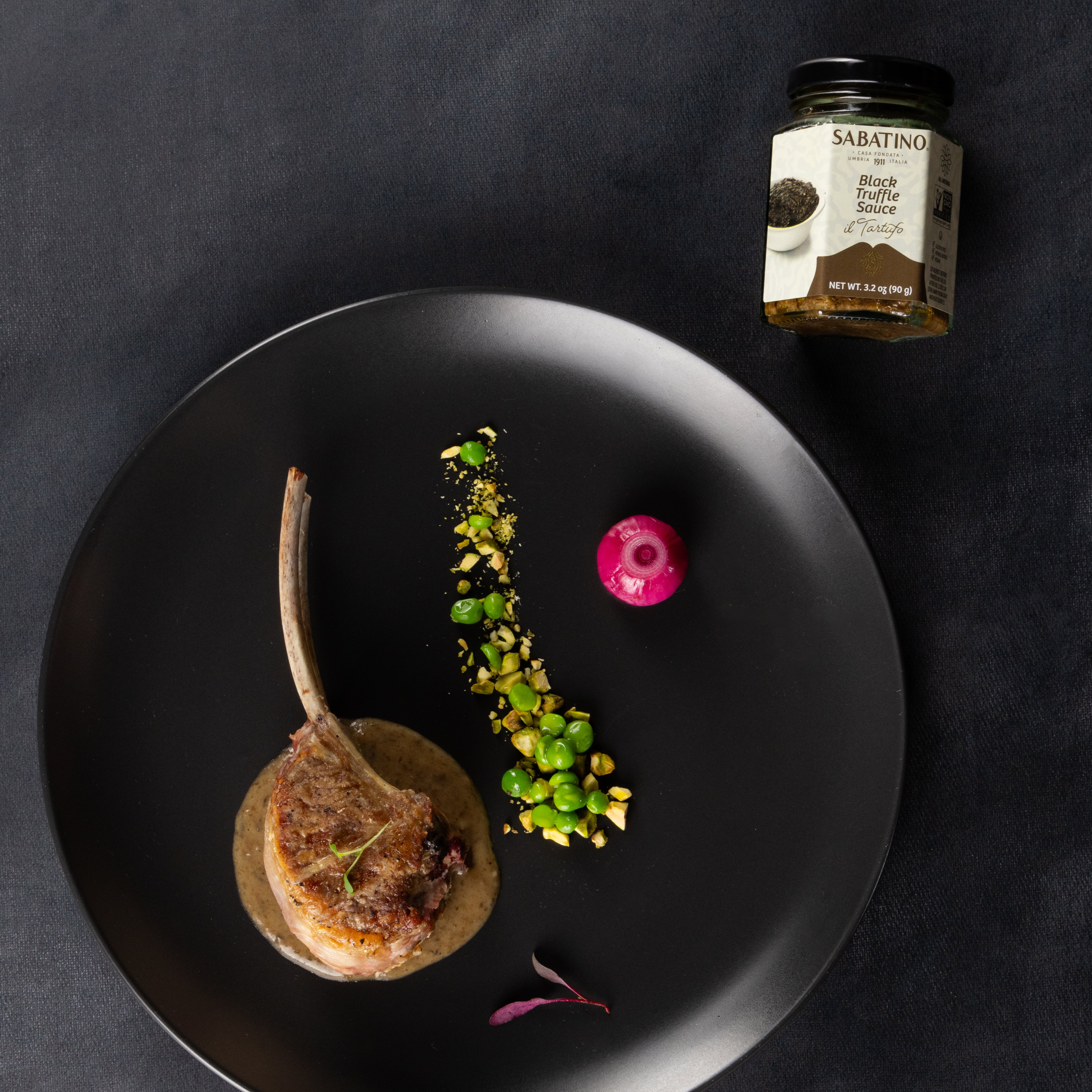 a plate of food and a jar of sauce