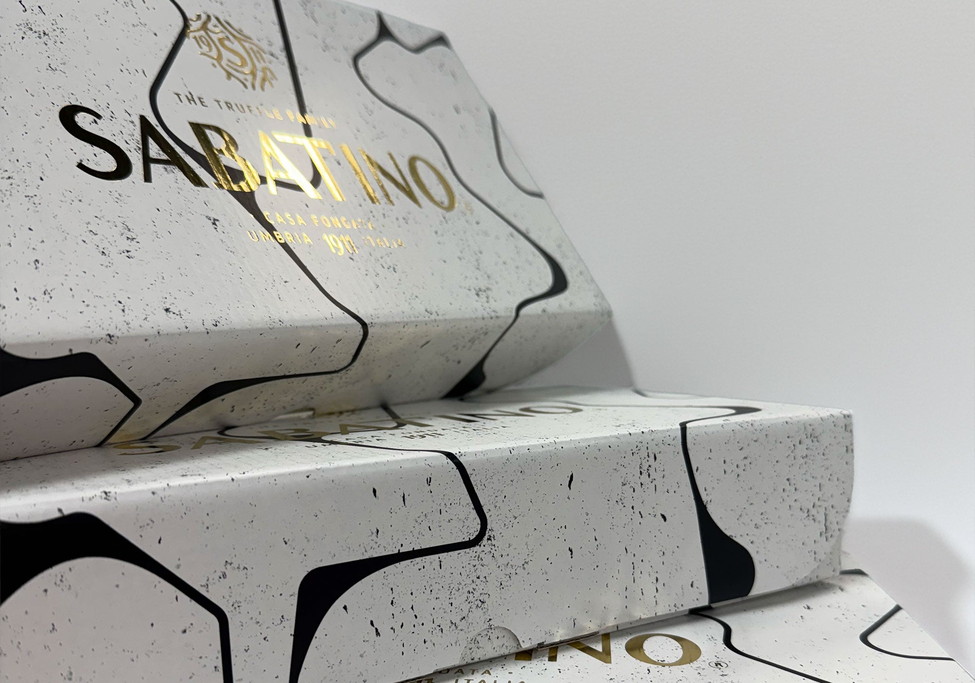 a stack of boxes with gold text