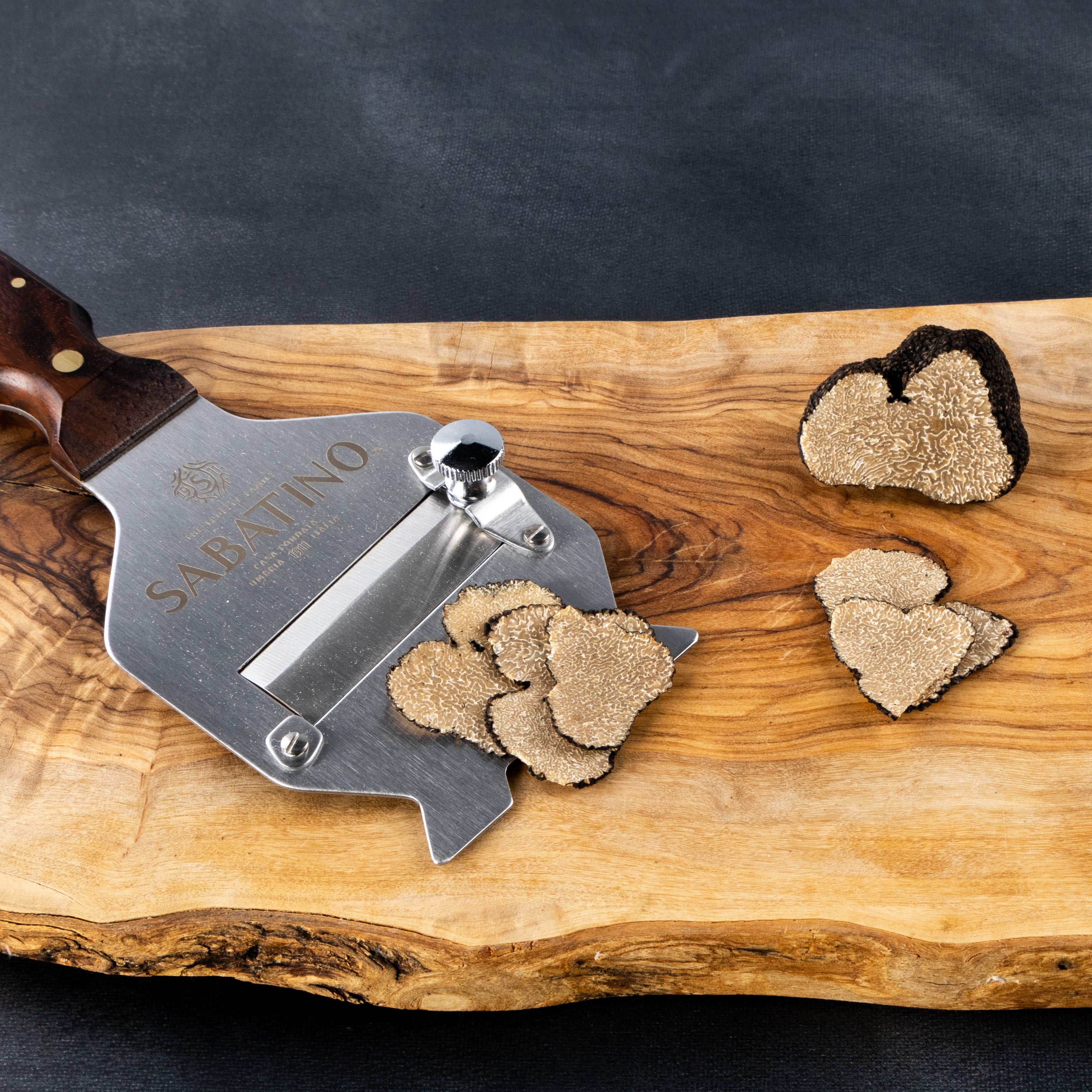 a slicer with a slicer and a slicer with a heart shaped object on a wood board