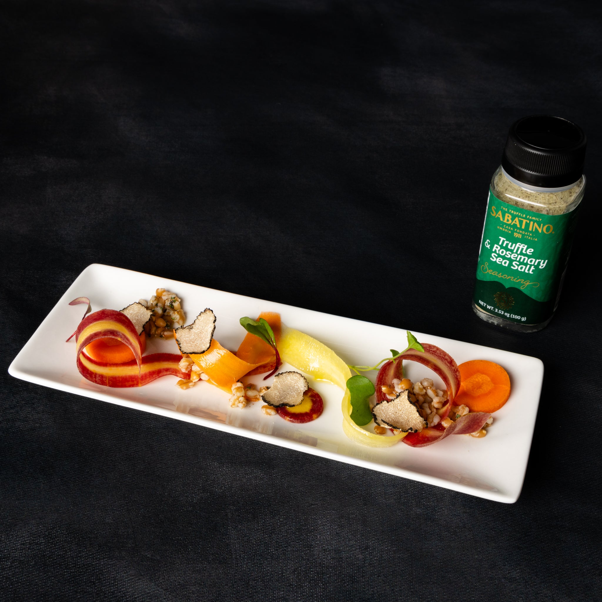 a plate of food and a bottle of seasoning