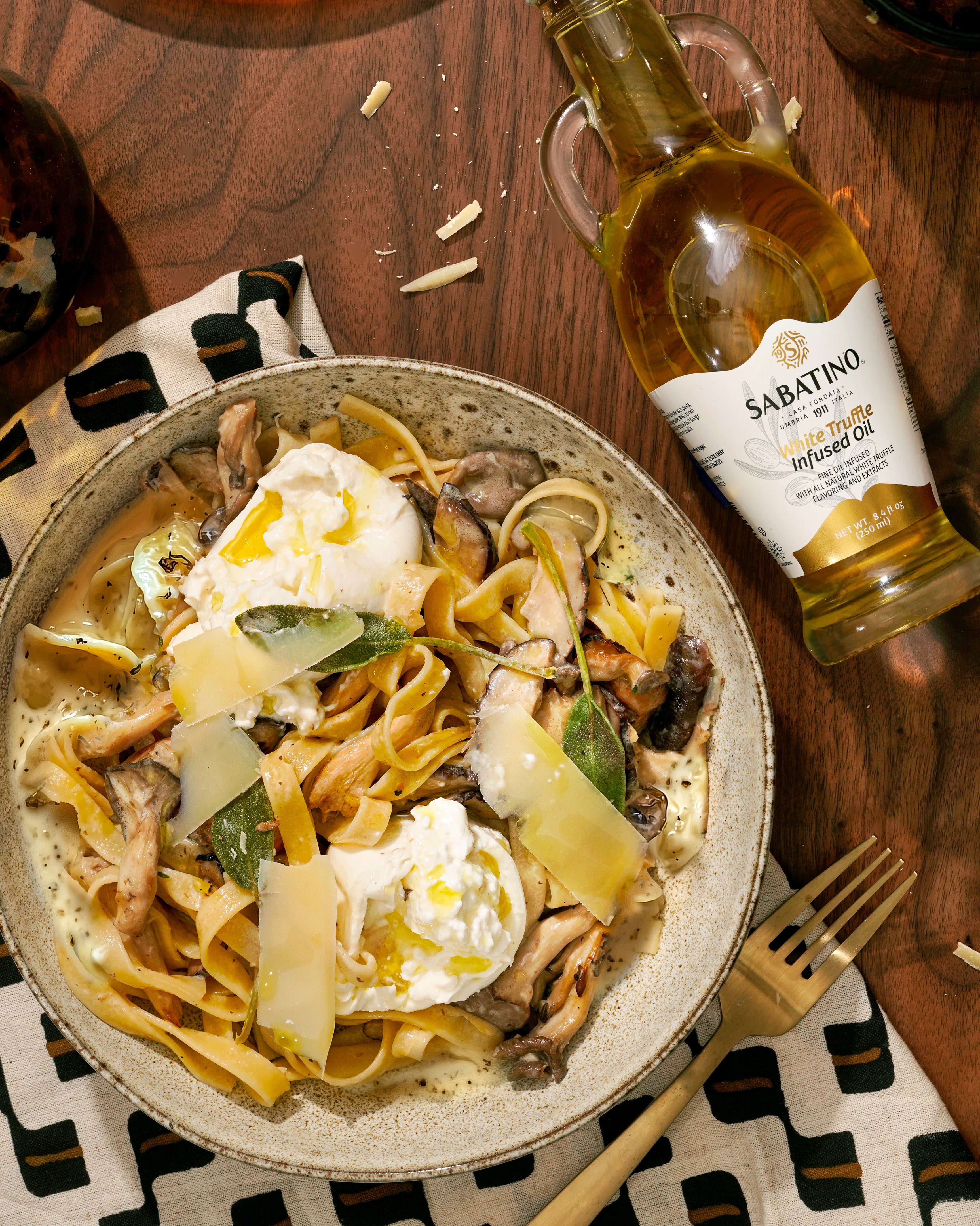 a bowl of pasta and a bottle of wine