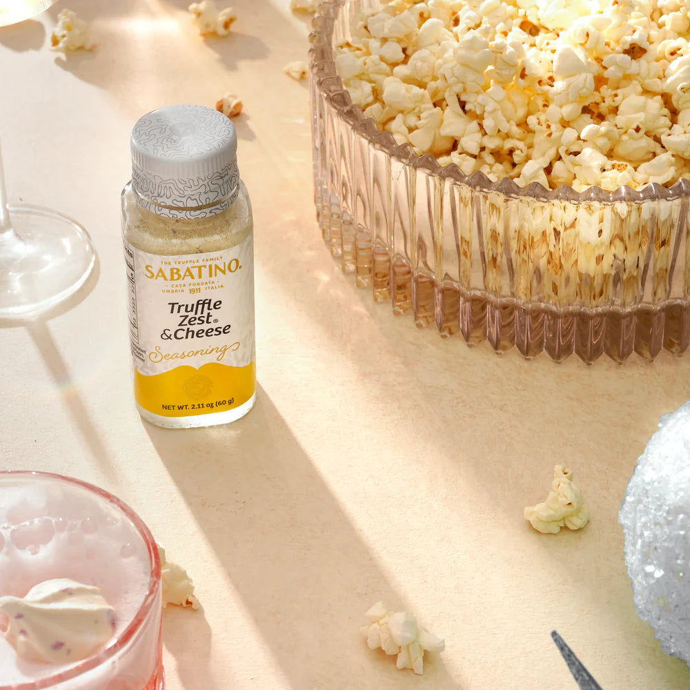 a bowl of popcorn and a glass of wine